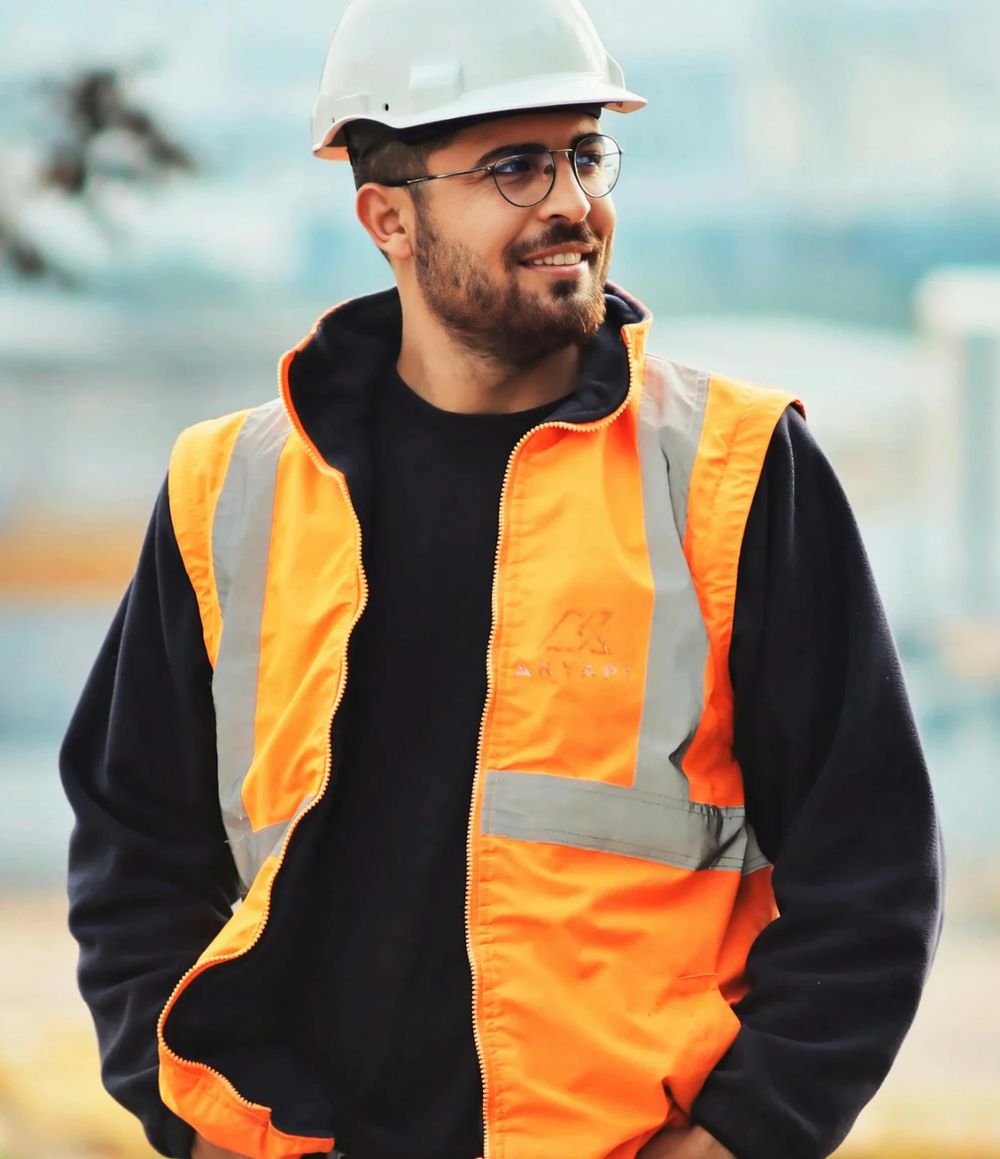 A worker in a hard hat and high-visibility vest